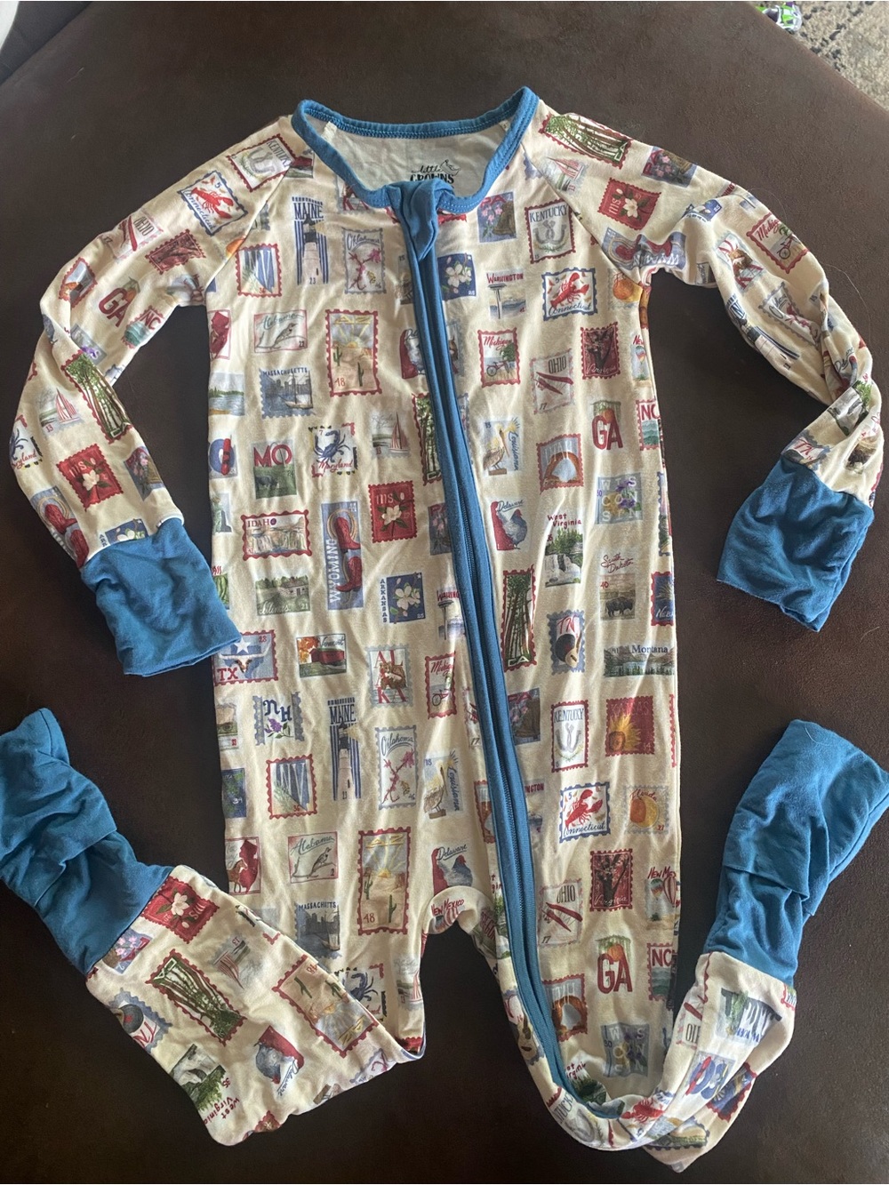 Little Crowns and Capes Cream One-Piece Footed Pajamas with Blue Trim